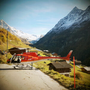 Helicopter landing on road in the Swiss Alps